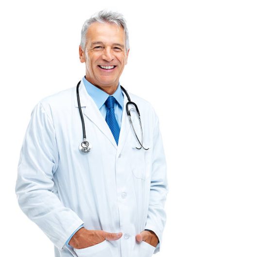 Portrait of happy mature medical doctor standing against white background